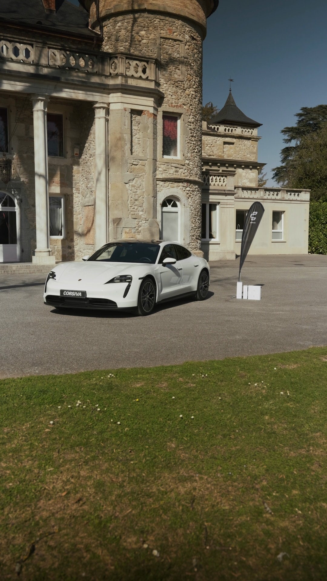 Porsche Taycan blanche filmée au château de Servolex, en Savoie